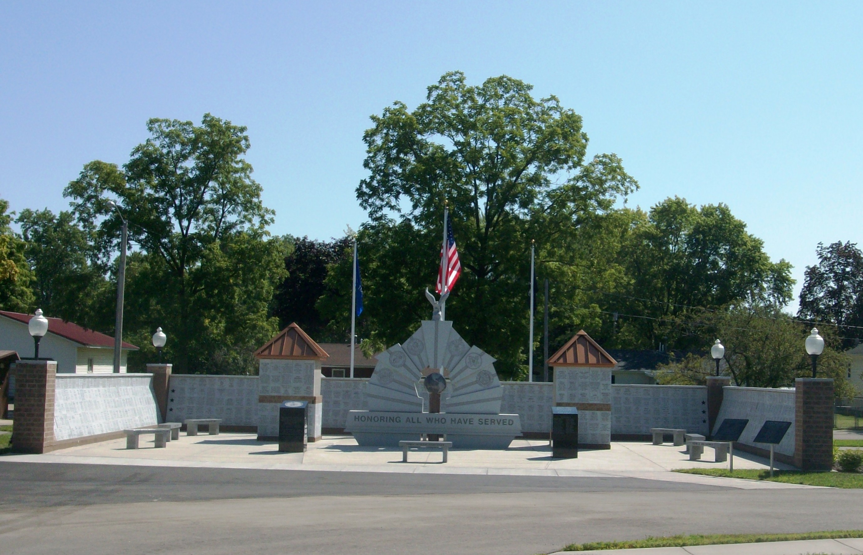 Military service memorial, flags, and trees in Tomah’s Memorial Park, photographed in 2013